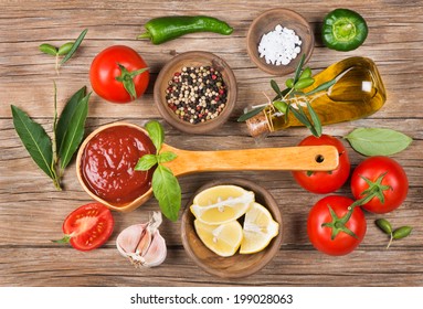  Homemade Tomato Sauce In A Wooden Spoon On Brown Table And Ingredients 