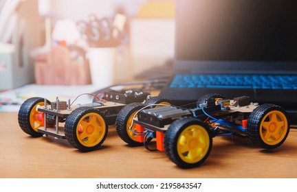 Homemade toy cars with microcontroller for teaching engineers to children.