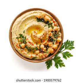 Homemade traditional hummus served on a ceramic plate on a white background, top view - Shutterstock ID 1900579762