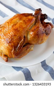 Homemade Traditional Rotisserie Chicken On White Plate, Low Angle View. Closeup.