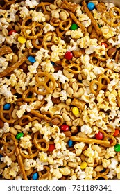 Homemade Trail Mix For Kids With Chocolate Candy, Popcorn, Pretzels And Nuts Overhead Shot