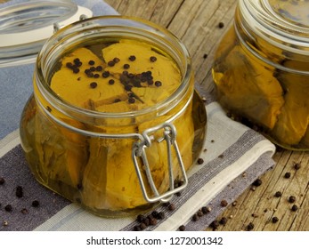 Homemade tuna preserve with extra virgin olive oil and black pepper in a glass jar on old wooden table. - Powered by Shutterstock