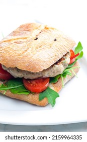 Homemade Turkey Burger With Cherry Tomatoes And Arugula In Ciabatta