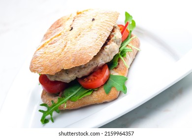 Homemade Turkey Burger With Cherry Tomatoes And Arugula In Ciabatta