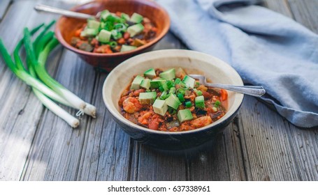 Homemade Turkey Vegetable Chili with Avocado and Scallions. Selective focus, toning.