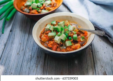 Homemade Turkey Vegetable Chili with Avocado and Scallions. Selective focus, toning.