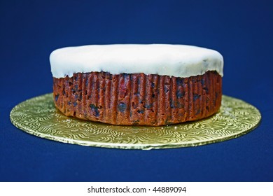 Homemade Undecorated Fruit Cake On Gold Coloured Stand.