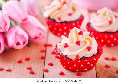 Homemade Valentine Cupcakes With Red Sugar Hearts And Pink Tulips On Wooden Background