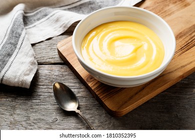 Homemade vanilla custard pudding or lemon curd in a white  bowl.