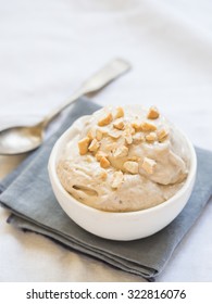 Homemade vegan banana ice cream (here, halva flavored, with tahina) served with cashew nuts. - Shutterstock ID 322816076