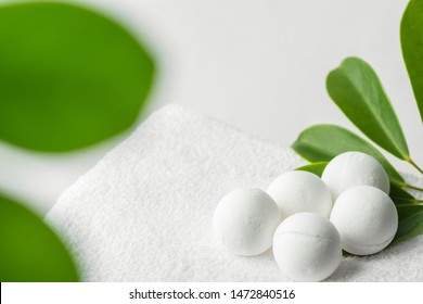Homemade vegan bath bombs on white cotton terry towel green houseplant in bathroom. Spa wellness body care relaxation beauty concept. Poster with copy space