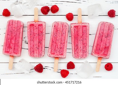 Homemade Vegan Raspberry Coconut Milk Popsicles - Ice Pops - Paletas With Chia Seeds On Rustic White Wooden Background