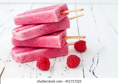 Homemade Vegan Raspberry Coconut Milk Popsicles - Ice Pops - Paletas With Chia Seeds On Rustic White Wooden Background