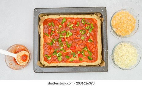 Homemade Vegetarian Pizza Recipe. Pizza Dough With Tomato Sauce And Fresh Chopped Vegetables Close Up On Baking Pan, Flat Lay