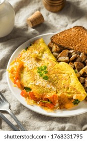 Homemade Veggie Omelette With Cheese Potatoes And Toast