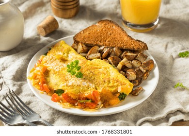 Homemade Veggie Omelette With Cheese Potatoes And Toast