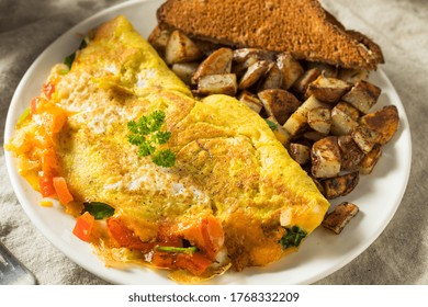 Homemade Veggie Omelette With Cheese Potatoes And Toast