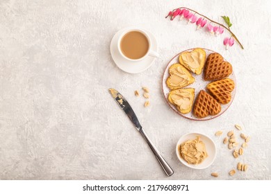 Homemade Waffle With Peanut Butter And Cup Of Coffee On A Gray Concrete Background. Top View, Flat Lay, Copy Space.