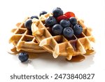 homemade waffles, adorned with fresh blueberries and drizzled with golden syrup