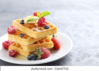 Homemade waffles with berries in plate on grey table - Powered by Shutterstock