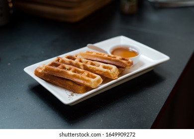 homemade waffles stick with maple syrup in mini cafe