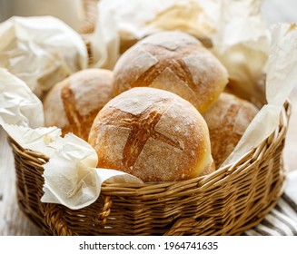 Homemade wheat rolls freshly baked in a wicker basket, close up view. Homemade breakfast