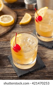 Homemade Whiskey Sour Cocktail Drink With A Cherry Lemon