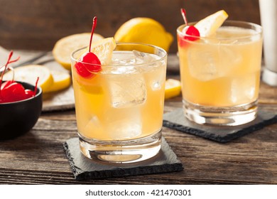 Homemade Whiskey Sour Cocktail Drink With A Cherry Lemon
