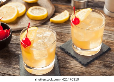 Homemade Whiskey Sour Cocktail Drink With A Cherry Lemon