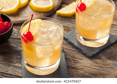 Homemade Whiskey Sour Cocktail Drink With A Cherry Lemon