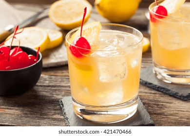 Homemade Whiskey Sour Cocktail Drink With A Cherry Lemon