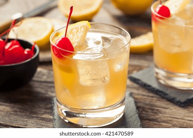 Homemade Whiskey Sour Cocktail Drink With A Cherry Lemon