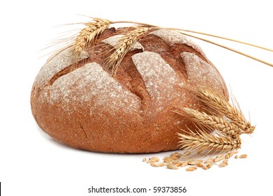 Homemade Whole Bread And Stalks Of Wheat On A White Background