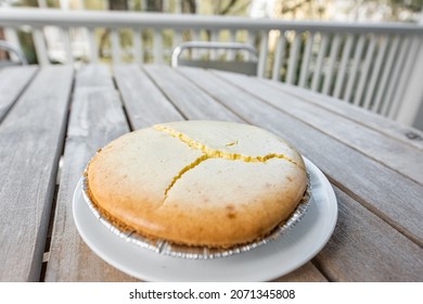 Homemade Whole Plain Cheese Cake Cheesecake On Plate Outside Wooden Table Background With Cracked Cracks Cooking Fail Due To Temperature