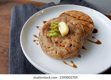 Homemade whole wheat english crumpets with butter and honey. - Powered by Shutterstock