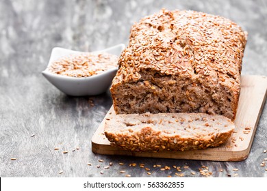 Homemade  wholemeal rye bread with flax seeds on wooden table 