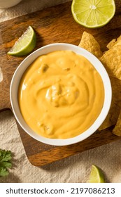 Homemade Yellow Queso Cheese Dip With Tortilla Chips And Lime