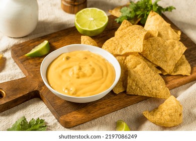 Homemade Yellow Queso Cheese Dip with Tortilla Chips and Lime