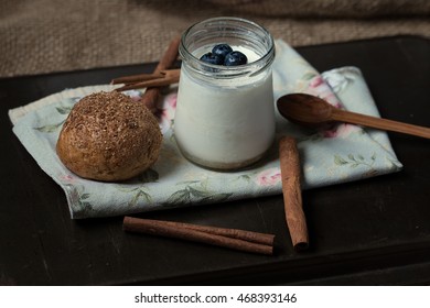 Homemade Yogurt With Blueberry, Bran Muffin And Cinnamon On A Linen Napkin