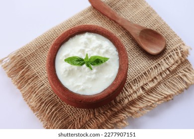 Homemade yogurt or Indian dahi. Curd in clay pot made from cow milk. Sour cream or natural Cottage cheese	