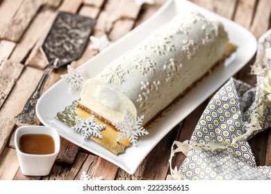 Homemade yule log with pear, white chocolate and caramel - Shutterstock ID 2222356615