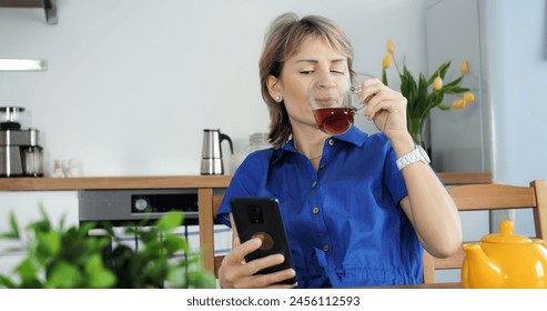 Homemaker using smartphone, domestic life and technology blend. Cinematic kitchen scene, modern woman multitasking, cozy home vibe. Homemaker's life balanced with technology, smartphone use. - Powered by Shutterstock