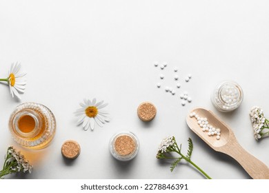 Homeopathic medicines and medicinal plants on a light background, copy space