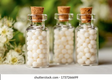 Homeopathy globules in bottles. homeopathy, naturopathy and alternative medicine. Alternative homeopathy medicine concept.