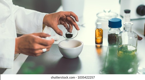Homeopathy lab. Homeopath preparing alternative herbal medicines.