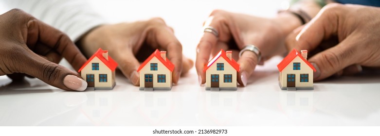 Homeowner Association By People Holding House Model On White Surface - Shutterstock ID 2136982973