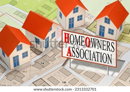 Homeowner Association concept with residential homes models against an imaginary city map and text