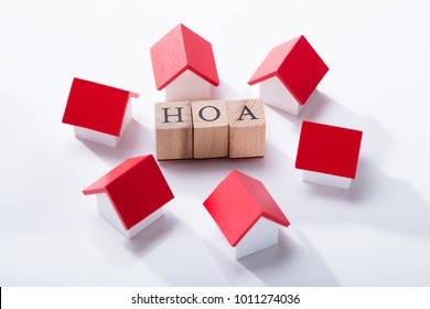 Homeowner Association Wooden Blocks Surrounded With Miniature House Models Over The White Background - Shutterstock ID 1011274036