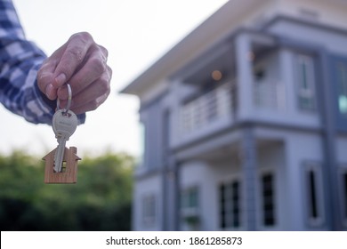 Homeowner Holding A New House Key From A Broker After Agreeing To Buy A Mortgage-home Investment. Concept Buying A House , A New Home.