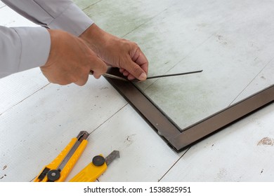 Homeowner Repairing His Window Screen